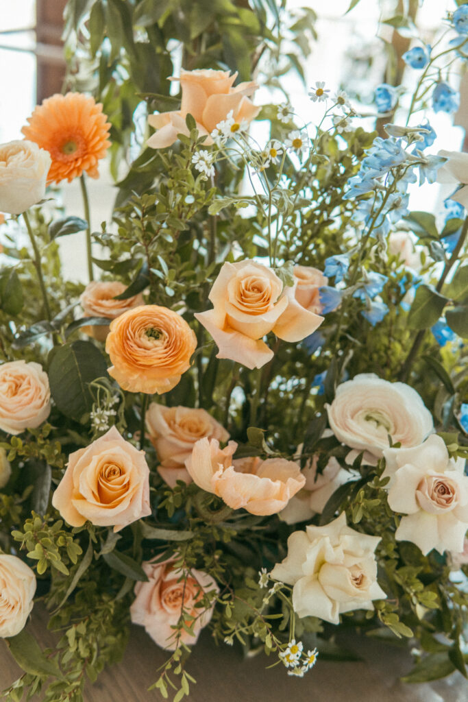 Peach, blush, and blue wedding florals